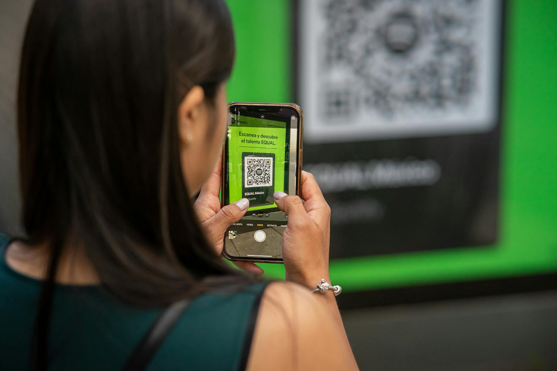 woman taking photos of a qr code with a smartphone